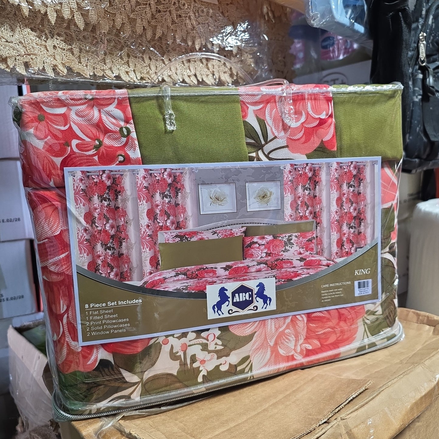 8-piece King-size bedding set featuring a floral print with red and green tones. This set is a "bed-in-a-bag" style, which conveniently includes a flat sheet, a fitted sheet, two print pillowcases, two solid pillowcases, and two matching window panels